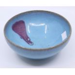 A blue glaze Studio pottery bowl with abstract purple glaze decoration to interior