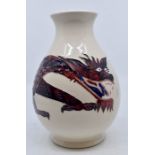 Moorcroft Pottery: A Moorcroft Pottery 'Dragon' baluster vase. Purple and blue dragon on cream body.