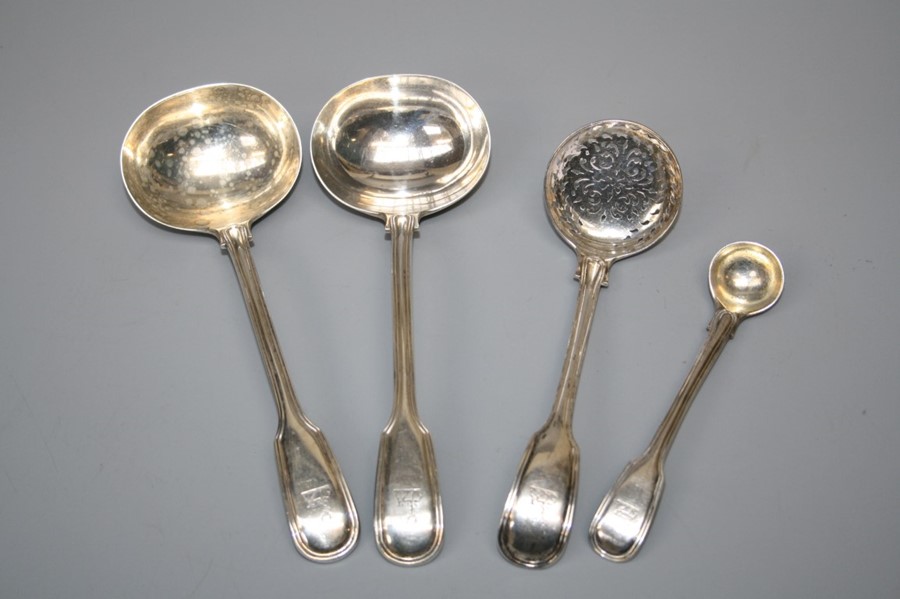 A pair of Victorian "fiddle and Thread" pattern silver sauce ladles and sugar sifting spoon.