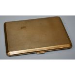 An early 20th century heavily made 9ct yellow gold rectangular cigarette case with engine turned