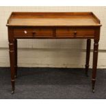 A 19th century mahogany washstand with low upstand over a frieze drawer, on turned tapering legs and