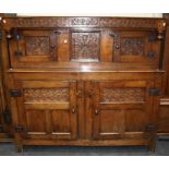 A largely 18th century oak court cupboard, the carved frieze dated 1709 over central carved panel