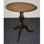 A  Geo III style mahogany circular dish topped, tripod wine table.