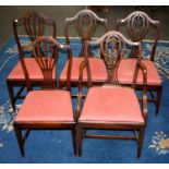 A set of six 19th century mahogany shield back dining chairs, each with waisted fleur de lys