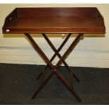 An early 19th century mahogany single-sided butlers tray and folding stand. The tray with shaped