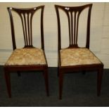 A set of Six Edwardian satinwood strung mahogany salon chairs with concave cresting rails. Raised on