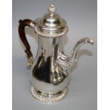 A Geo III baluster form silver coffee pot with shell and feather gadrooned decoration and hinged