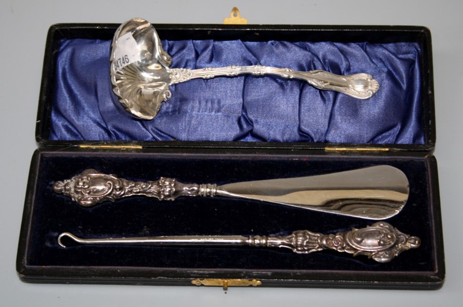 An American Sterling silver sauce ladle, together with a presentation cased button hook and shoe