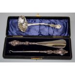 An American Sterling silver sauce ladle, together with a presentation cased button hook and shoe