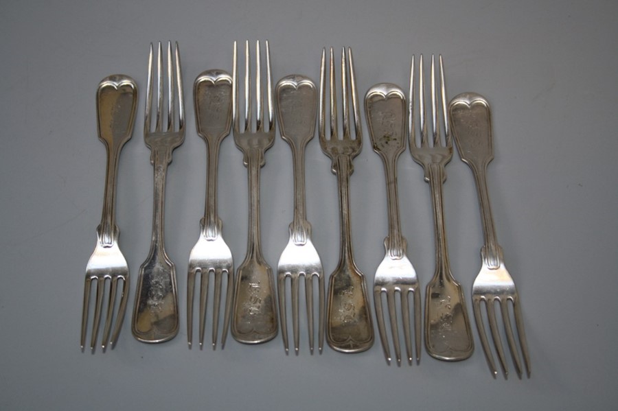 A part set of nine white metal fiddle and thread dessert forks, each monogrammed LSB. 11 troy oz.