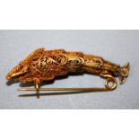 An early 20th century possibly Venetian yellow metal filligree sturgeon(?) brooch with beaded eyes