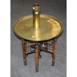 An ealy 20th century Middle Eastern brass tray top table with bobbin turned folding base, together