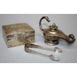 A silver lamp form table lighter, a silver cigarette box and a pair of sugar nips. Various dates and