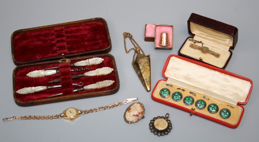 A cased set of early 20th Century silver and green enamel buttons, a 9ct gold bar brooch, a lady's