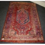 A 20th century Hamadan rug, the central stepped lozenge medallion on a red/blue ground. Fringed