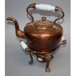 A 19th century copper spirit kettle and burner stand with Lions paw supports and milk glass handles.