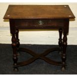 An early 18th century oak lowboy, the moulded edge top over frieze drawer on baluster turned