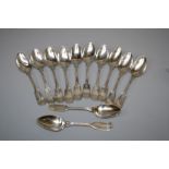 A set of twelve white metal fiddle and thread dessert spoons, each monogrammed LSB. 15 troy oz.