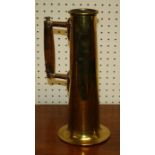 A brass shell case, worked as a sleeve vase with turned wood handle.30cm