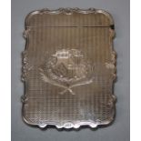 A Victorian silver cartouch form calling card case with engine turned and elaborate armorial crest