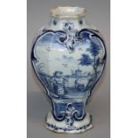An 18th Century Dutch Delft vase of moulded flattened baluster form, painted in cobalt blue with a