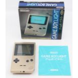 Nintendo: A boxed Gameboy Light Console, Gold, MGB-101, with instructions. Slight wear to battery