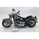 Franklin Mint: A boxed Harley Davidson 1998 Fat Boy by Franklin Mint. Boxed with papers and Hemet.