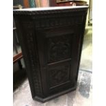 A 19th Century carved oak corner hanging cupboard, height 72cm