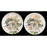 A pair of 19th century style Chinese famille verte chargers, each decorated with battling figures on