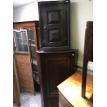 A George III country oak wall hanging corner cupboard, single panel door with a drawer below, height