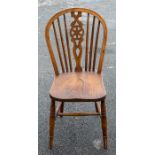 An early 20th century elm wheelback High Wycombe edition of the Windsor chair. 92cm H x37cm W x 39cm