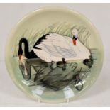 A Moorcroft plate, Swans, limited edition 32/350 Designed by Sally Tuffin. Diameter approx 25.7cm.