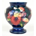 The Mitchell Collection of Moorcroft Pottery: A Moorcroft 'Orchid' pattern U3 shape vase on blue