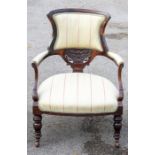 A Victorian mahogany open armchair, shaped padded back above a carved and pierced splat, padded