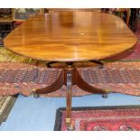 A Regency mahogany twin pedestal extending rounded rectangular dining table, with one leaf, turned
