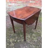 A George III mahogany Pembroke table, circa 1790, oval flaps, single frieze drawer, tapered block