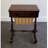 A Victorian rosewood combined work and games table, the swivel top folding out as a games table, the