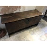 A late 17th Century oak plank chest, wire hinges, the front with chip carved roundels and