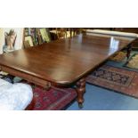 A Victorian mahogany rounded rectangular extending dining table, four leaves, moulded edge over deep