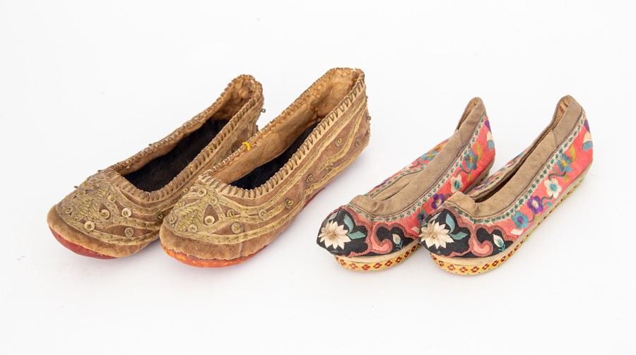 Two pairs of hand embroidered children's Oriental shoes, one pair is a gold embellished slip on