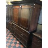 A George III mahogany linen press, circa 1800, dentil cornice, blind fret chinoiserie frieze, twin