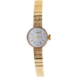 A 9ct gold ladies Longines wrist watch, round silvered dial approx 15mm, applied baton markers, case