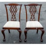A set of four Chippendale style mahogany dining chairs, 20th Century, having pierced back splats,