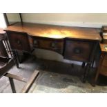 A George III mahogany breakfront sideboard, circa 1810, single frieze drawer flanked by a deep