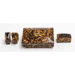 A late 19th Century tortoiseshell mounted sarcophagus shaped jewellery box, fitted red velvet