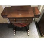 A mid Victorian mahogany work table, circa 1860, breakfront top with frieze drawers and silk and