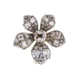 A early 20th Century diamond set flower brooch, comprising a claw set central old cushion cut