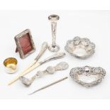A collection of silver items to include two pin dishes, small bud vase, a small silver frame with