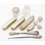 A collection of dressing table items to include silver topped table jars,  silver handled shoe