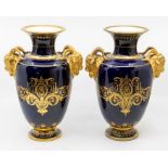 A pair of 19th century Vienna ovoid blue ground twin-handled vases, flared necks with gilt rims